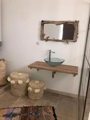a bathroom with a sink and a mirror on the wall at LA POINTE D’ASPRETTO in Ajaccio
