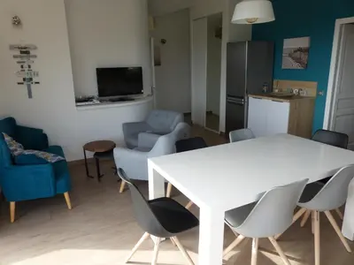 a living room with a white table and chairs at BAVELA in Porto-Vecchio