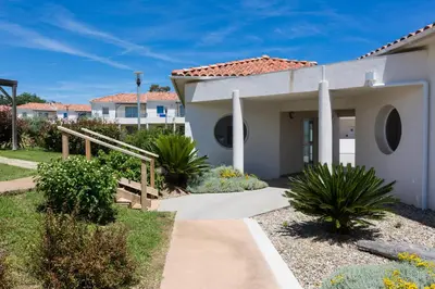 a house with a pathway in front of it at Résidence Odalys Acqua Bella in Poggio-Mezzana