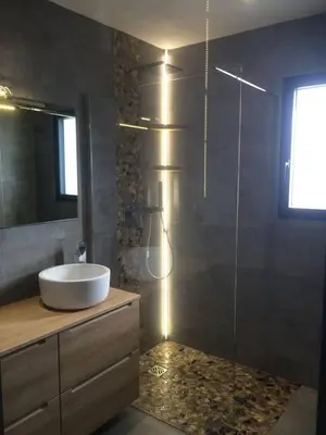a bathroom with a sink and a glass shower at Villa entre Mer et Montagne... in Calenzana