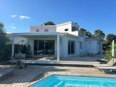 a villa with a swimming pool and a house at A BARMETTA in Porto-Vecchio