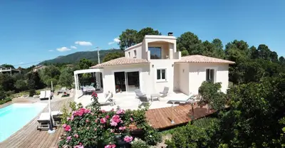 a villa with a swimming pool and a house at A BARMETTA in Porto-Vecchio
