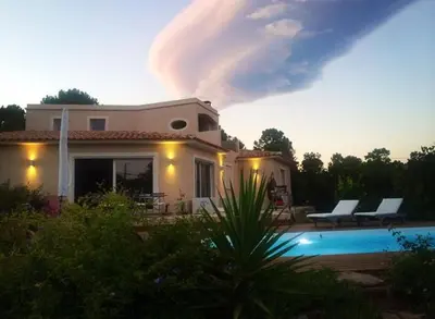 a house with a swimming pool in front of it at A BARMETTA in Porto-Vecchio