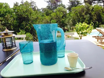 a tray with a pitcher and two glasses on a table at A BARMETTA in Porto-Vecchio