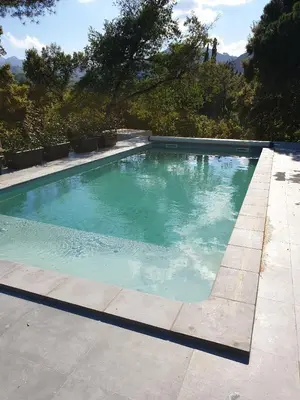 a large swimming pool with blue water at Casa San Niolo in Cervione