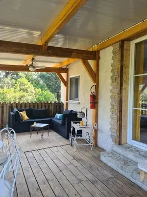 a patio with a couch and a table on a deck at Casa San Niolo in Cervione