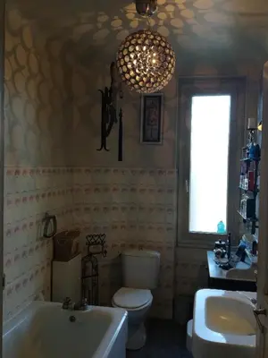 a bathroom with a tub and a toilet and a sink at Villa Cécile in Ajaccio