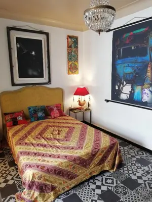 a bedroom with a bed and a painting on the wall at Villa Cécile in Ajaccio