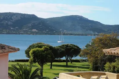 a view of a lake with a boat in the water at Appartement 2 pièces Pied dans l'eau in Porto-Vecchio