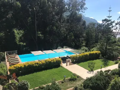a house with a swimming pool in a garden at Les résidences du port appartements meublés in Porto Ota