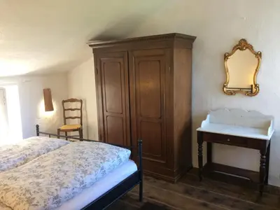 a bedroom with a bed and a dresser and a mirror at Casa Franceschi in Pioggiola