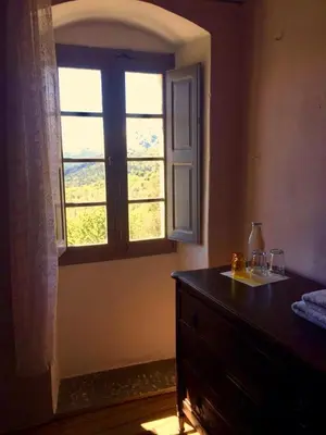 a bedroom with a window and a dresser with a dresser at Casa Franceschi in Pioggiola