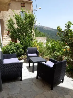 a group of chairs and tables on a patio at Casa Franceschi in Pioggiola