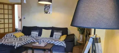 a living room with a bed and a blue lamp at maison de village T4 in Poggio-dʼOletta