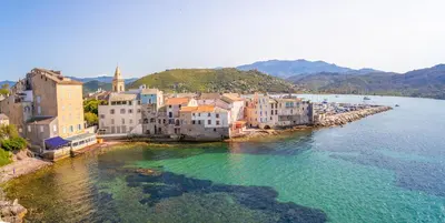 a group of buildings on the shore of a body of water at maison de village T4 in Poggio-dʼOletta