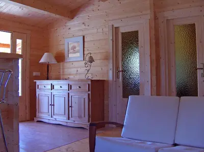 a living room with a couch and a cabinet in a cabin at chalet climatisé Porticcio Corse in Fontanaccio