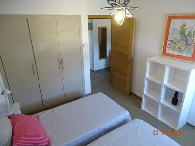 a room with a bed and a room with cabinets at Résidence Coté Plage in Sainte-Lucie de Porto-Vecchio