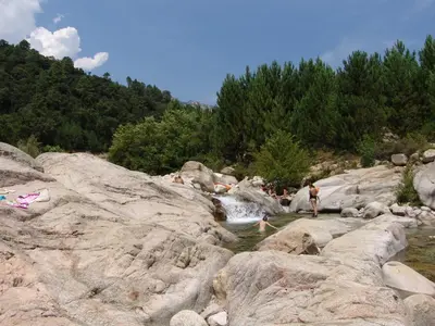 a group of people swimming in a river at Résidence Coté Plage in Sainte-Lucie de Porto-Vecchio