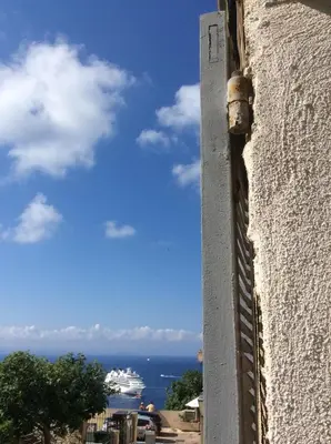 a view of the ocean and a cruise ship at Au cœur de la cité médiévale avec petite vue mer in Bonifacio