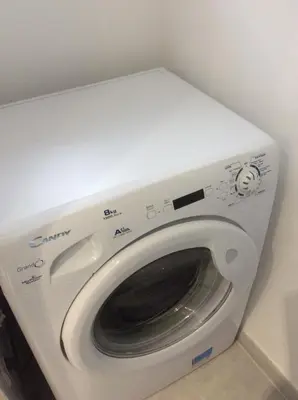 a white washer and dryer in a room at Au cœur de la cité médiévale avec petite vue mer in Bonifacio