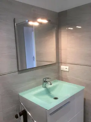 a bathroom with a sink and a mirror at Au cœur de la cité médiévale avec petite vue mer in Bonifacio