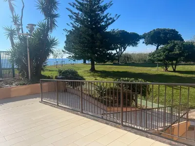 a metal gate with a park behind it at Appartement n 216 Moriani plage in Santa-Lucia-di-Moriani