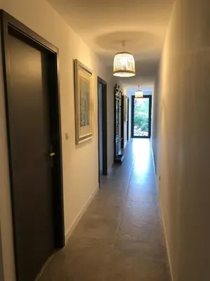 a hallway of a house with a door and a chandelier at VILLA LECCI E MARE in Olmucciu