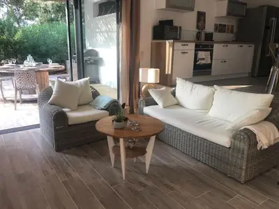 a living room with two couches and a table at VILLA LECCI E MARE in Olmucciu