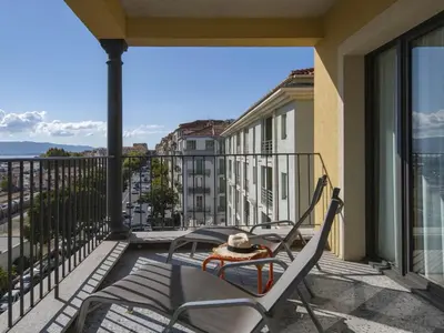 a balcony with a table and chairs on a balcony at ibis Styles Ajaccio Napoleon in Ajaccio