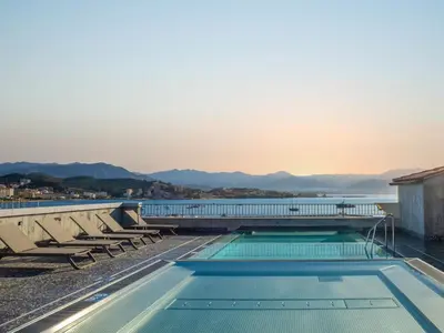 a swimming pool on the roof of a building with a view at ibis Styles Ajaccio Napoleon in Ajaccio