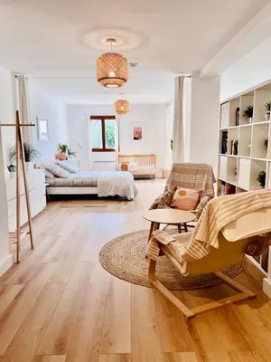 a living room with a couch and a bed at Loft entre mer et campagne à 5 min d'Ajaccio classé 4 étoiles in Alata