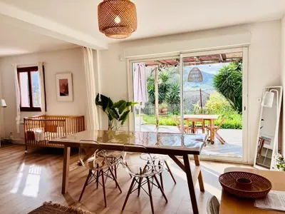 a dining room with a glass table and chairs at Loft entre mer et campagne à 5 min d'Ajaccio classé 4 étoiles in Alata