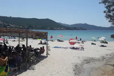 a group of people sitting in chairs on a beach at PIETROSELLA Plage du RUPIONE in Pietrosella