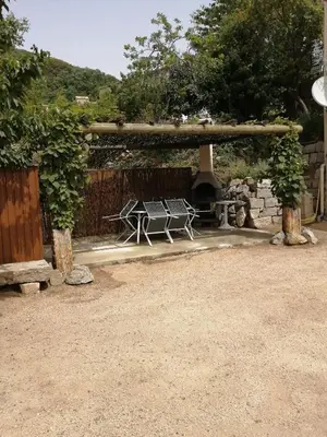 a patio with a picnic table and a fireplace at Fresi Gustave in Levie