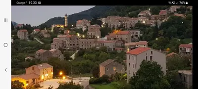 a town on a hill with houses and lights at Fresi Gustave in Levie