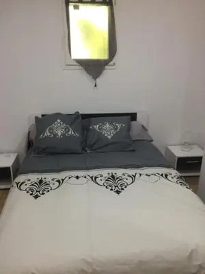 a bedroom with a bed with two pillows and a window at Fresi Gustave in Levie