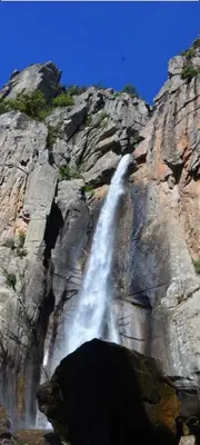 a waterfall on the side of a rocky mountain at Fresi Gustave in Levie