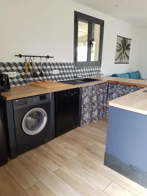 a kitchen with a washing machine and a counter at Entre mer et montagne, en plein maquis in Vallecalle