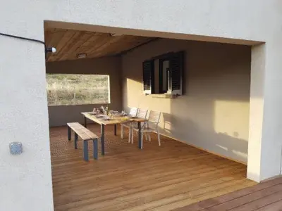 a dining room with a table and chairs in a room at Entre mer et montagne, en plein maquis in Vallecalle