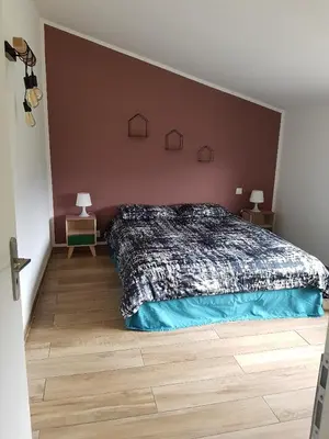 a bedroom with a bed and two end tables with lamps at En plein maquis,entre mer&montagne in Vallecalle