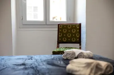 a room with a table with a chair and a towel at Madonuccia - Hypercentral Chic & Cosy in Ajaccio