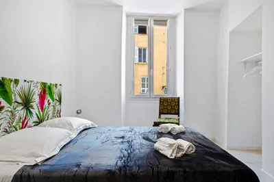 a bedroom with a bed with towels on it at Madonuccia - Hypercentral Chic & Cosy in Ajaccio