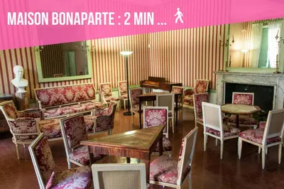 a room with tables and chairs and a fireplace at Madonuccia - Hypercentral Chic & Cosy in Ajaccio