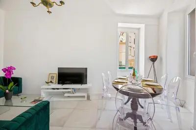 a living room with a glass table and a tv at Madonuccia - Hypercentral Chic & Cosy in Ajaccio