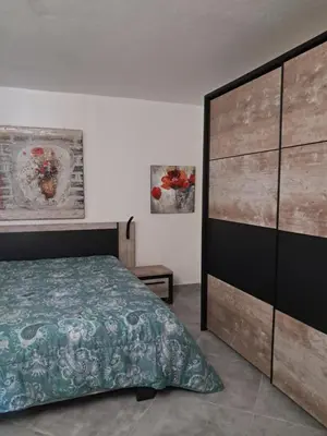 a bedroom with a large bed and a large dresser at Villa Giuseppina in Bonifacio