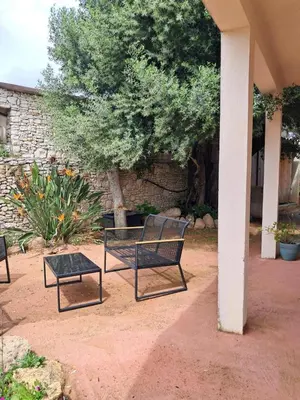 a patio with two benches and a table at Villa Giuseppina in Bonifacio