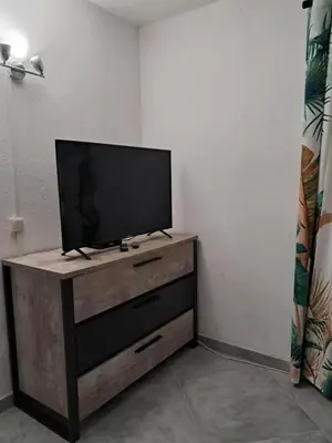 a flat screen tv sitting on top of a wooden dresser at Villa Giuseppina in Bonifacio