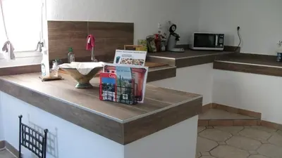 a counter with books on it in a kitchen at T2 dans la région Bastiaise vue sur la mer in Furiani