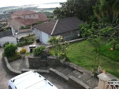 a white car parked in front of a house at T2 dans la région Bastiaise vue sur la mer in Furiani