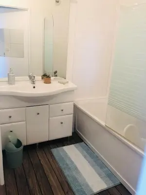 a bathroom with a sink and a tub and a mirror at Superbe appartement 3 étoiles Ajaccio début Sanguinaires in Ajaccio